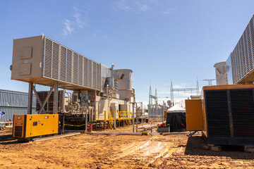 Construction of the firts natural gas energy plant of central america, trucks, construction machinery, workers, turbines and storage tanks.