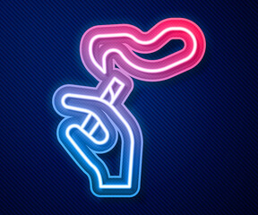 Glowing neon line Hand with smoking cigarette icon isolated on blue background. Tobacco sign. Vector