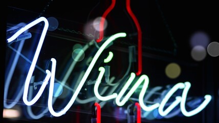 Glowing fragment of a neon sign, close-up, abstract background. Bokeh light flare.