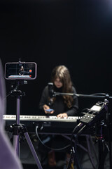 The process of recording video content for learning to play the piano.