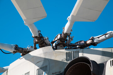 Bushings and automatic-skew helicopter silver color against a blue sky on a clear sunny day Military equipment atom planes missiles helicopters.