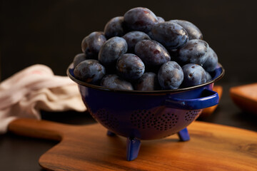 Blue plums in a collander