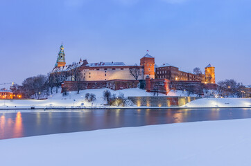 Krakow winter, night Wawel Castle over Vistula river, snow, Poland