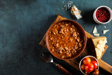 classic italian bolognese sauce with ingredients on blue background. Bolognese sauce top view. culinary background with space for text. Pasta bolognese. Italian lasagna