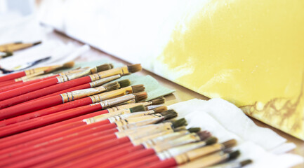 A set of red brushes for painting, close-up.