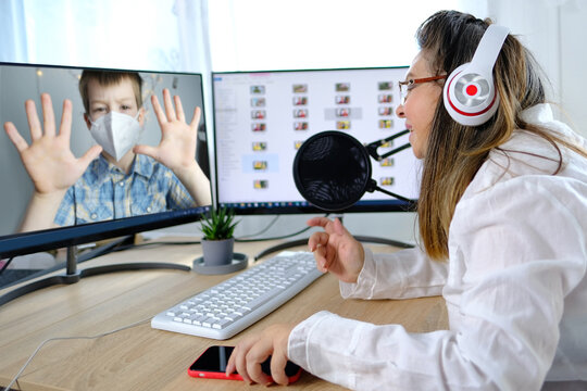 Woman Nutritionist In A White Blouse 40-45 Years Old Talks With A Child About Nutrition And Health, Concept Of Healthy Lifestyle, Physical Activity, Online Consultation During Quarantine Covid 19