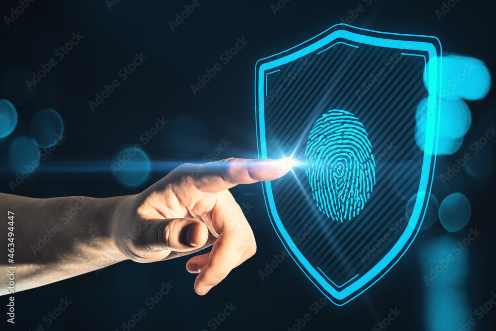 Poster close up of businessman hand pointing at creative glowing blue finger print and shield interface on 