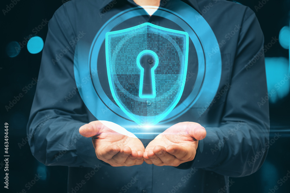 Poster close up of businessman hands holding glowing shield and padlock hud on blurry background. safety an