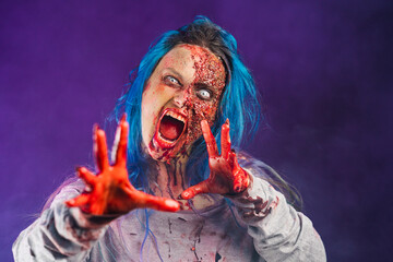 Woman with bloody scary zombie makeup with white eyes and blue hair