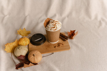 Coffee Take Away Cup in Autumn Pumpkin Set Up. Pumpkin spice latte with whipped cream and fresh cinnamon. Coffee to go with Cream and Cinnamon on Top. Autumn Latte Cinnamon