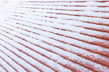Roof tiles covered in snow in winter, UK