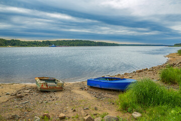 Fototapeta premium Old boats on the river bank. Russia, Volga river