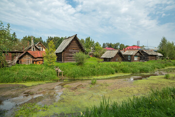 Old wooden houses in the summer village. Russia