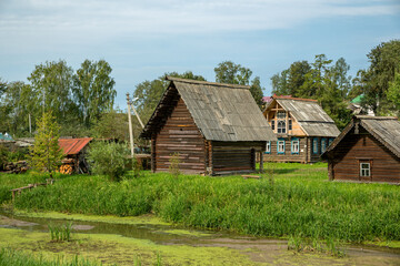 Fototapeta na wymiar Old wooden houses in the summer village. Russia