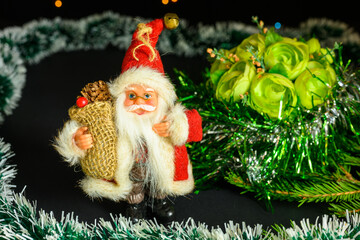 Santa Claus with glasses and a bag of gifts.