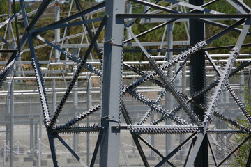 Close-up view of a segment of the steel structure of an electric distribution tower