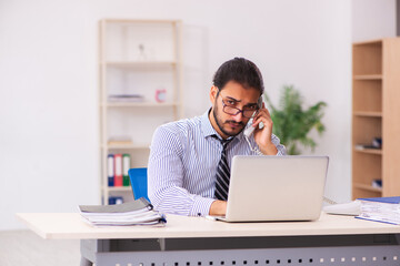 Young male employee working in the office