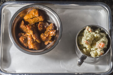American barbecue tray with pork belly and potato salad