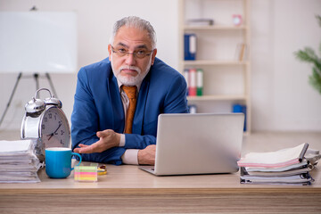 Old businessman employee in time management concept