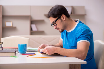 Young male student studying at home