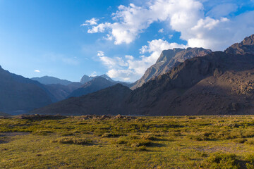 mountain sunset landscape with grass and clouds