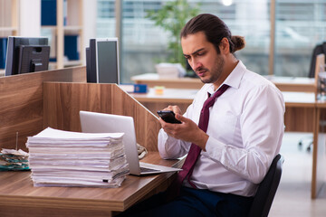 Young male employee and too many work in the office