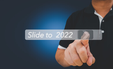 Man using finger slide a virtual button to unlock for 2022 year, Year two thousand and twenty two concept. Concept for new year 2022. Unlock the New year