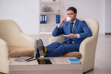 Young male employee waiting for business meeting