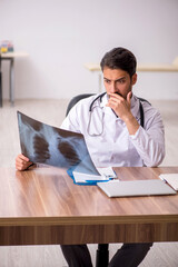 Young male doctor radiologist sitting in the clinic