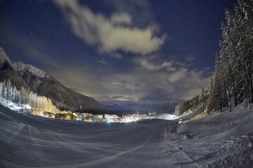 Ski slopes at night under the stars in the sky