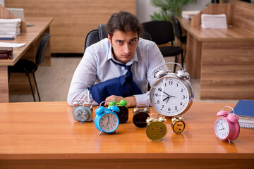 Young male employee sleeping in the office in time management co