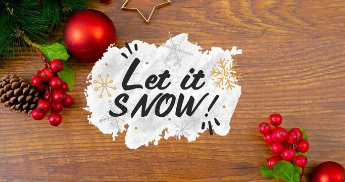 Animation of let it snow christmas text and decorations on wooden background