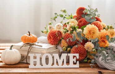 Autumn composition with a bouquet of chrysanthemums and decorative word home.