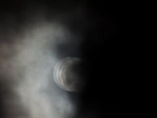 Moon on cloudy weather reminding eclipse and phasing