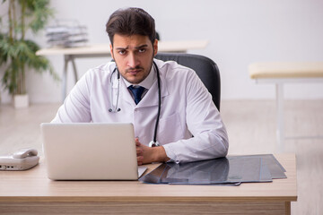 Young male doctor in telemedicine concept