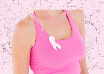 Mid section of woman wearing a pink ribbon on her sleeve against textured pink background