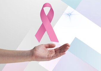 Hand holding an invisible object against pink ribbon icon on colorful striped background
