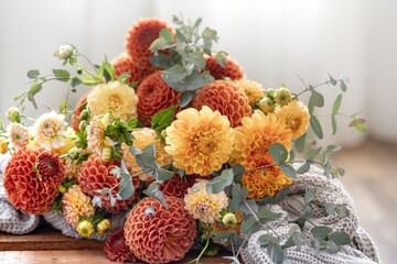 A bouquet of yellow and orange chrysanthemums on a blurred background.