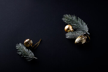 Christmas ornaments on dark paper background. Close up. Copy space.