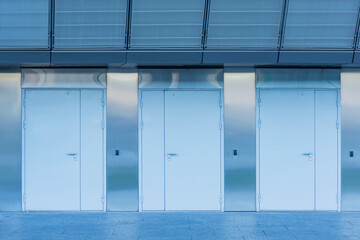 Three closed doors of the new building.