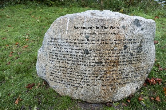 
Vancouver, BC Canada - October 14, 2021:  Vancouver in the Rain by Writer Regan Andrade Etched on Stone in Urban Park near Kitsilano Beach
