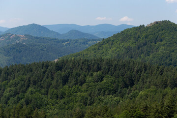 Fototapeta na wymiar Rhodopes, are a mountain range in Southeastern Europe. Panorama. The forest area covers the mountains.
