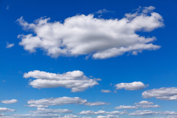 Naklejka na ściany i meble Flying white clouds in the summer day . Blue daytime sky 