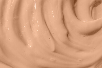 Cosmetic tonal moisturizer, bb cream swatch sample. Beige nude liquid foundation texture, concealer smear smudge drop. Make up base, cream textured background. Closeup macro