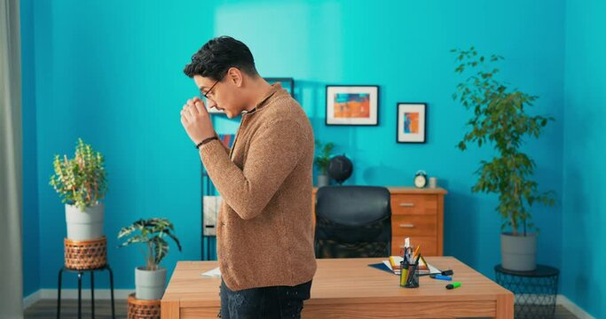 Confused unhappy thoughtful worried employee walks back and forth around the corporate office takes off and puts on glasses pensive trying to solve corporate financial problems puts on hands helpless