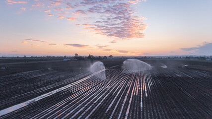 Fototapeta premium Water sprinklers on a ploughed field near Gin Gin, Queensland