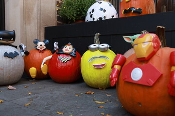 A townhouse with Halloween pumpkins and Halloween decorations in the evening on a city street. Trick or treat..