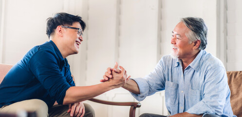 Fototapeta premium Portrait of happy love asian family senior mature father and young adult son play and looking together in moments good time at home