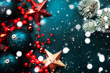 Blue Christmas or New Year background with blue Christmas balls, red berries and stars with...
