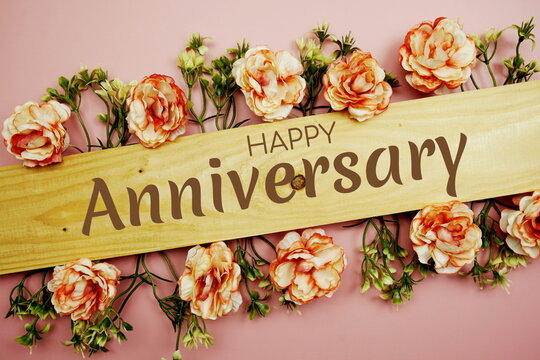 Happy Anniversary typography text and flower decoration on blackboard background